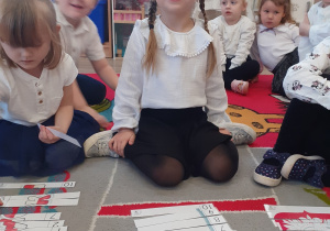 Zuzia układa patriotyczne puzzle.